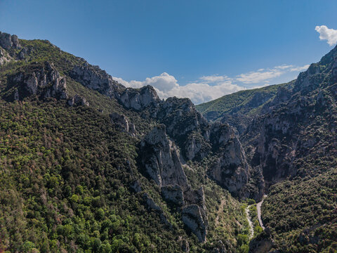 Aerial view of the Gorges de la Pierre-Lys and the Belvedere du Diable, featuring limestone cliffs, dense forests, and the winding Aude river in Belvianes-et-Cavirac, Occitanie, France.