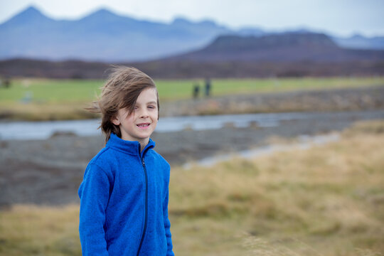 Child, playing on a road near non active vulcano in Snaefellsjokull National Park, Iceland autumntime