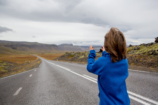 Child, playing on a road near non active vulcano in Snaefellsjokull National Park, Iceland autumntime
