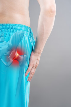 Hip dysplasia, joint inflammation, man suffering from pain, pelvic osteoarthritis, painful area in red with illustration anatomical skeleton