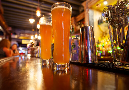 Two pints of beer on a generic looking bar