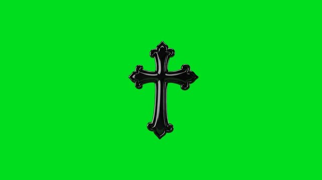 A glossy black ornamental cross centered on a vibrant green screen background