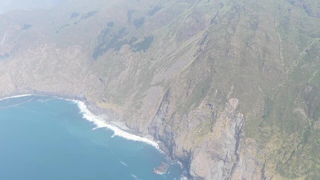 A sweeping aerial shot captures the dramatic cliffs and rugged coastline around Garita da Herbeira, near Meizoso, Spain.