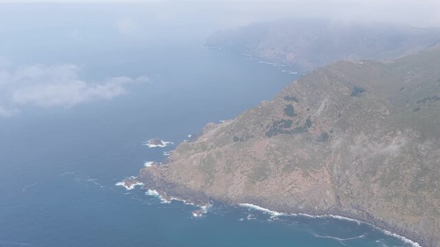 Wide aerial footage capturing the dramatic rocky coastline and steep cliffs around Garita da Herbeira near Meizoso, Spain.