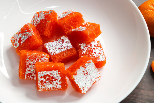 Nagpur Orange Barfi. Traditional Indian mithai made with milk solids and fresh Nagpur orange pulp. Soft, creamy fudge texture with tangy citrus flavor, inspired by India&rsquo;s Orange City.