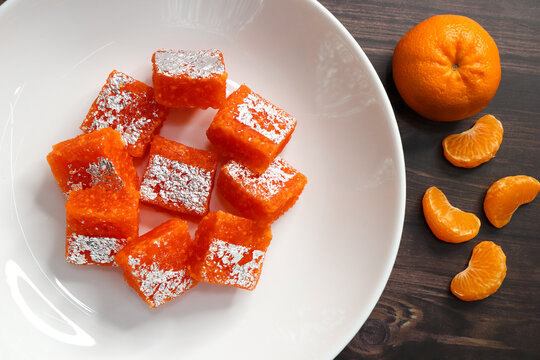 Nagpur Orange Barfi. Traditional Indian mithai made with milk solids and fresh Nagpur orange pulp. Soft, creamy fudge texture with tangy citrus flavor, inspired by India&rsquo;s Orange City.