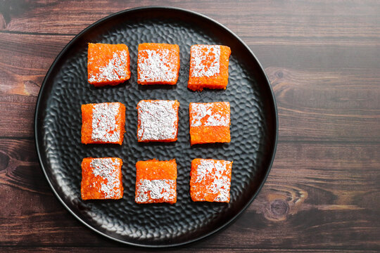 Nagpur Orange Barfi. Traditional Indian mithai made with milk solids and fresh Nagpur orange pulp. Soft, creamy fudge texture with tangy citrus flavor, inspired by India&rsquo;s Orange City.