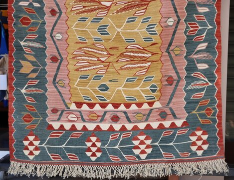 A detail of a kilim featuring traditional motifs. An example of the Turkish art of hand-weaving, showcasing geometric and floral patterns.
