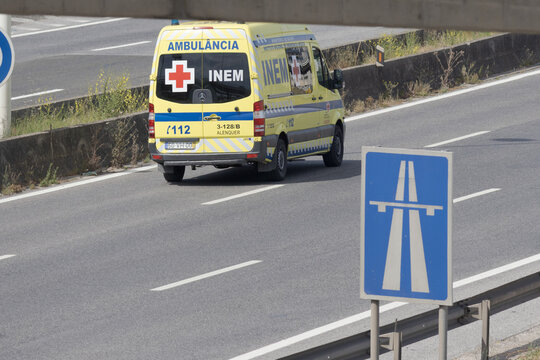 Portuguese inem ambulance driving on highway during daytime