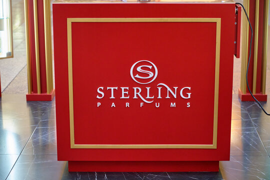 Sterling Parfums brand display in red and gold with a distinctive logo at a retail store or shopping mall - Moscow, Russia, August 11, 2026