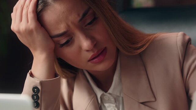 Frustrated upset Caucasian business woman looking at large long paper check with finance expense bills debt depressed female girl businesswoman worried with money annual taxes bankruptcy at office