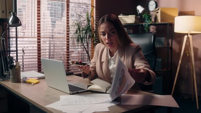 Panic stressed Caucasian business woman chaotic work talking phone searching data in documents looking laptop troubled multitasking businesswoman female girl suffer deadline problem working at office