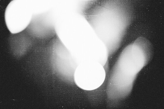 retro film overlay effect with scratch dust and light leaks,retro grain noisy film distressed texture light leak flare on black background,black and white abstract background with bokeh