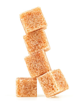 Brown cane sugar cubes isolated on a white background. Pieces of organic brown sugar.