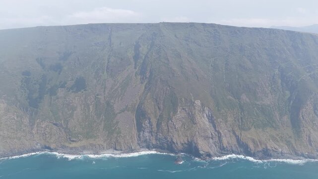 Aerial footage showcasing the dramatic, steep cliffs and rugged coastline around Garita da Herbeira in Meizoso, Spain.