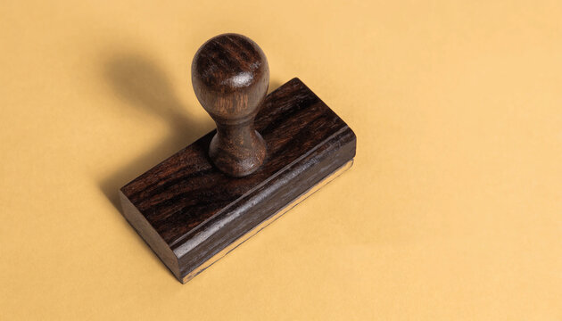 Approval concept, old fashioned wooden rubber stamp on yellow background with copy space