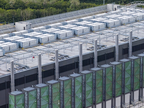 Aerial view of a modern data center facility featuring rows of cooling units and ventilation systems on the rooftop in Drogheda, County Louth, Ireland.
