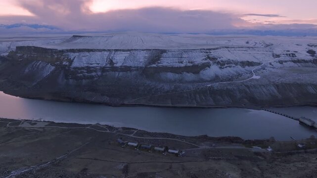 Aerial view of the snow-covered canyon walls and Snake River at sunset in the Morley Nelson Snake River Birds of Prey National Conservation Area in Murphy, Idaho, United States.