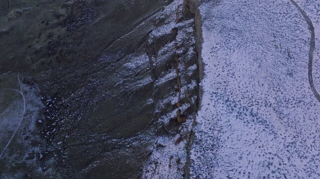 Aerial view of the rugged cliffs and snow-dusted landscape of the Morley Nelson Snake River Birds of Prey National Conservation Area in Murphy, Idaho, United States.
