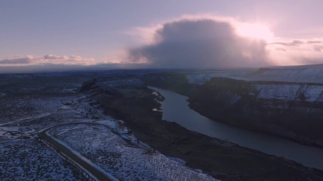 Aerial view of the snow-covered Snake River canyon at sunset within the Morley Nelson Snake River Birds of Prey National Conservation Area in Murphy, Idaho, United States.