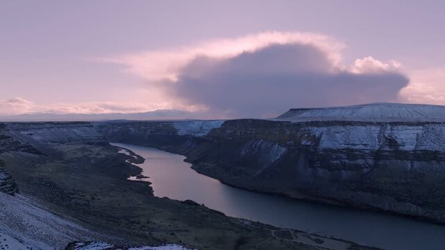 Aerial view of the Snake River winding through the snow-dusted cliffs of the Morley Nelson Snake River Birds of Prey National Conservation Area in Murphy, Idaho, United States.