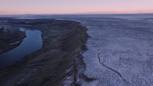 Aerial view of the Snake River winding through the snow-covered canyon of the Morley Nelson Snake River Birds of Prey National Conservation Area in Murphy, Idaho, United States.