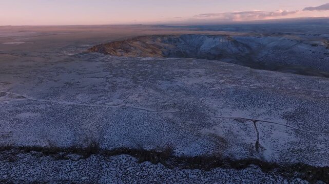 Aerial view of the rugged, snow-covered landscape of the Morley Nelson Snake River Birds of Prey National Conservation Area at sunset in Murphy, Idaho, United States.