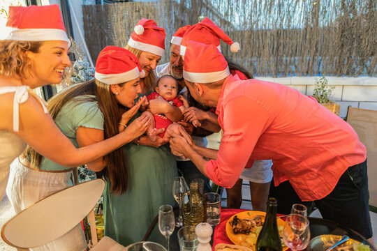 Family members celebrating christmas holiday with baby