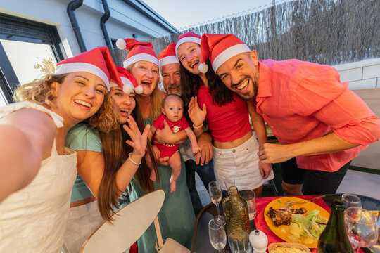 Happy family celebrating christmas holidays together taking selfie