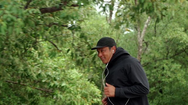 Happy active senior man jogging in nature after retirement. Healthy aging, fitness. Longevity outdoor lifestyle, preventive health, retirement happiness. Life insurance and financial security concept.
