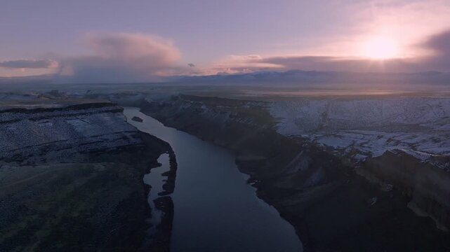 Aerial view of the Snake River winding through the canyon of the Morley Nelson Snake River Birds of Prey National Conservation Area at sunset in Murphy, Idaho, United States.