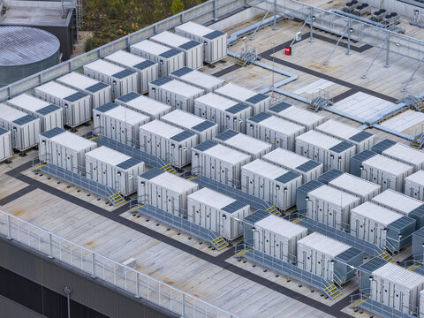 Aerial view of numerous industrial cooling units arranged in neat rows on a flat rooftop, featuring metal housing and maintenance walkways in Drogheda, County Louth, Ireland.