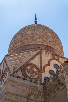 View of the intricate stone dome and geometric carvings of the Sultan Al-Ashraf Qaytbay Mosque and Mausoleum in El-Gamaleya, Cairo Governorate, Egypt.