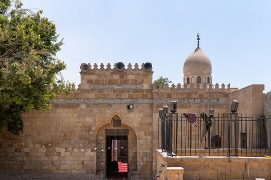View of Imam al-Layth Mosque with its stone facade, dome, and arched entrance in Cairo, Egypt.