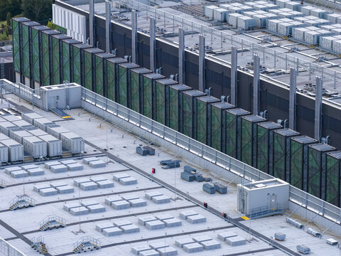 Aerial view of a large industrial data center facility featuring rows of rooftop HVAC units and sound-dampening ventilation screens in Drogheda, County Louth, Ireland.