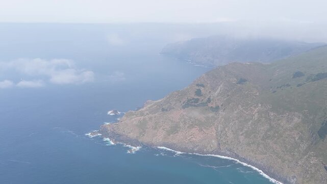 Aerial footage captures the dramatic, rugged coastline and steep cliffs surrounding Garita da Herbeira near Meizoso, Spain.