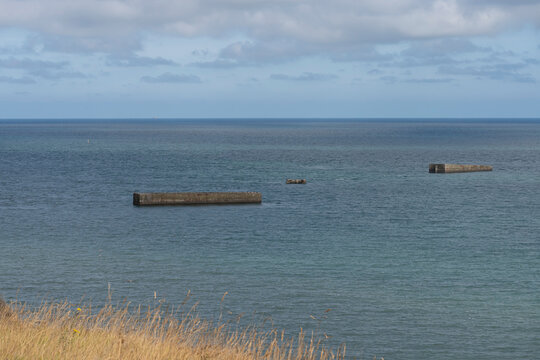 Arromanches-les-Bains, France - 08 10 2026:  Normandy landing blockhouse. Panoramic view of the artificial port with pontoons bridges and the sea
