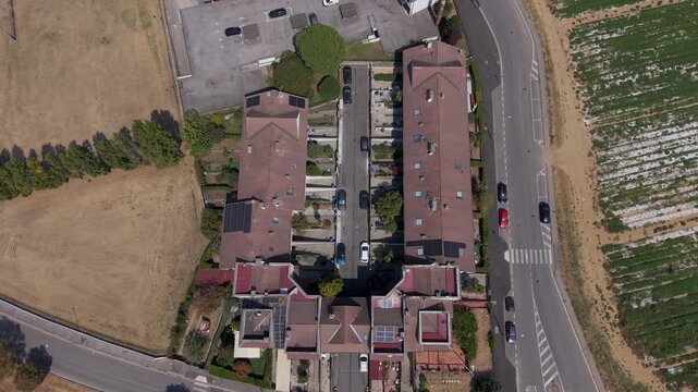 Top-down drone view of streets, houses and rooftops in Mediglia near Milan, capturing the residential landscape and everyday suburban character of Lombardy.
