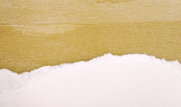 Torn White Paper Edge on Light Wooden Background with Copyspace for scrapbooking, collages, and craft design templates