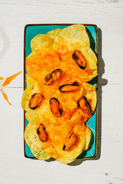 mussels and chips coated with escabeche sauce