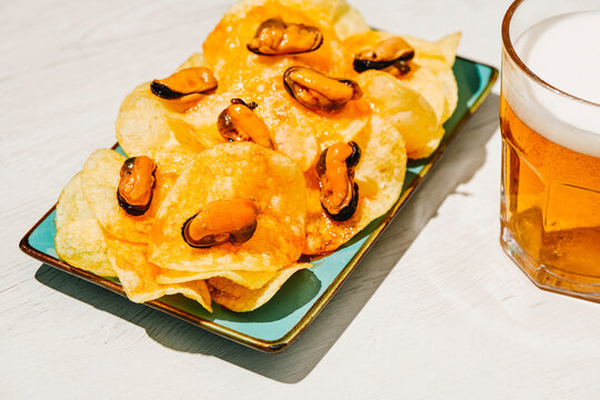 pickled mussels, chips and a glass of beer