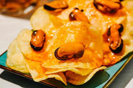 a mussel centered on escabeche-soaked chips