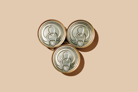 three unopened food cans arranged in a triangle
