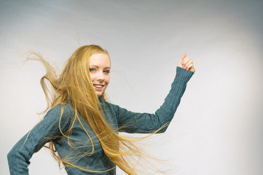 Smiling woman with blowing long hair
