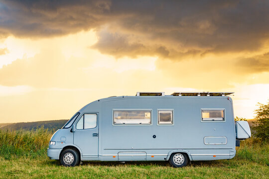 Sunset sky over caravan camping on nature.