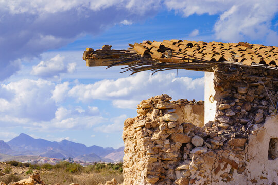 Ruined building, destroyed house with mountains view in the distance