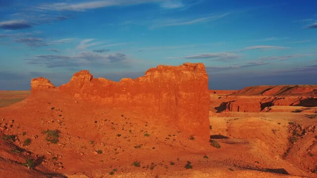 Aerial view of the red sandstone formations of the Flaming Cliffs under a clear blue sky in Bulgan, Omnogovi, Mongolia.