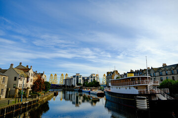 Fototapeta premium River passes through Leith, Scotland and reveals wind turbines under construction