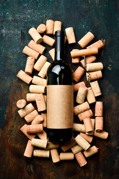 Wine in a bottle on the background of wine corks. Top view.