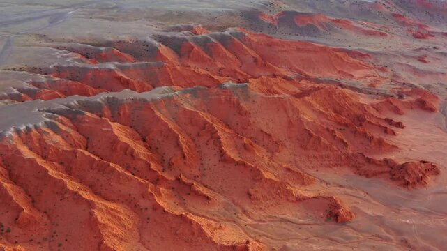 Aerial view of the red sandstone formations of the Flaming Cliffs in the Gobi Desert, Bulgan, Omnogovi, Mongolia.